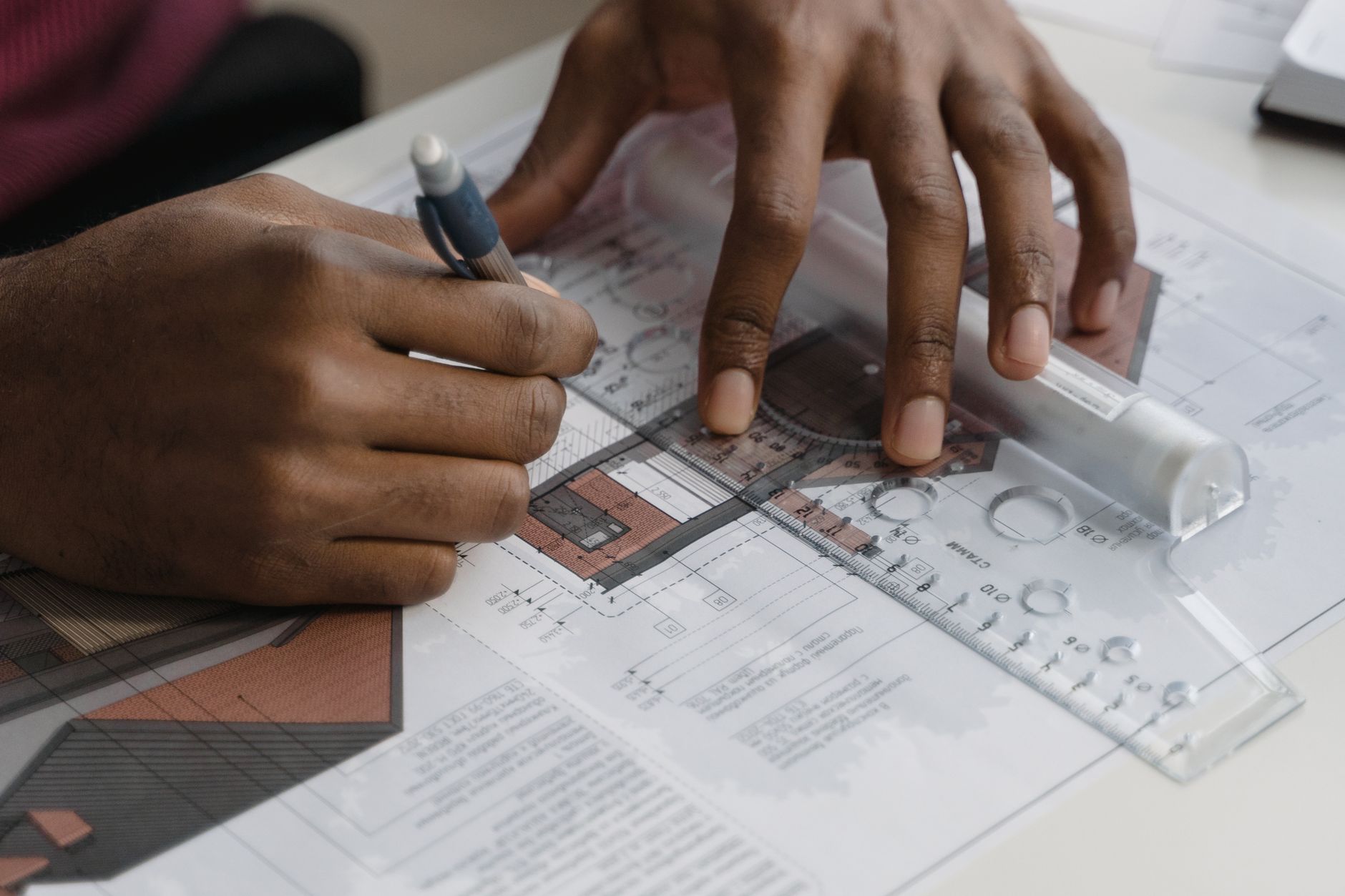 a person drawing a blue print